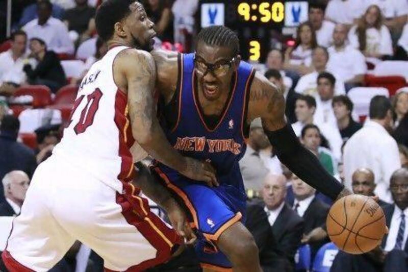 Amare Stoudemire, right, exited Miami with his left hand and arm in a sling after New York's 104-94 loss to the Heat in Game 2.