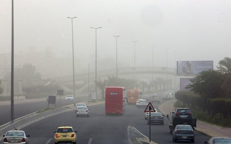 Vehicles drive along a motorway during a dust storm in Kuwait City. Visibility levels in some areas dropped to less than 600 metres. AFP