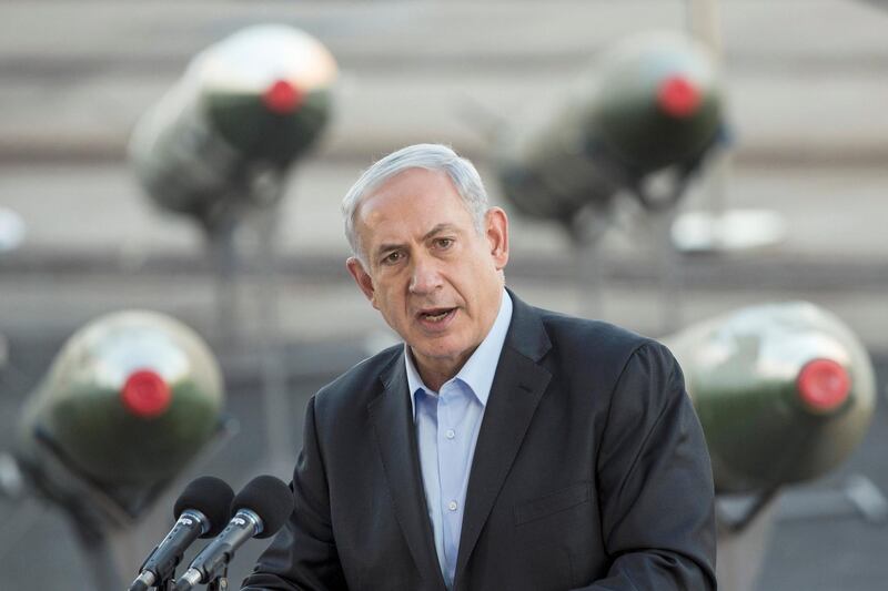 Israeli Prime Minister Benjamin Netanyahu speaks to the press at southern Israeli port of Eilat, on March 10, 2014,  as Israel displayed advanced rockets type M-302 that were unloaded from the Panamanian-flagged Klos-C vessel on March 9, 2014 in Eilat. The vessel, which was allegedly transporting arms from Iran to Gaza, was escorted into the port of Eilat after Israeli naval commandos seized it on March 5, 2014. AFP PHOTO / JACK GUEZ (Photo by JACK GUEZ / AFP)