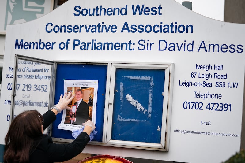 A photograph of Sir David Amess is placed on a noticeboard outside the Iveagh Hall, the home of the Southend West Conservative Association in Leigh-on-Sea. AP
