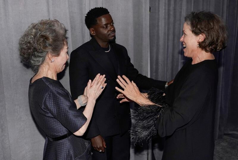 Youn Yuh-jung, Best Supporting Actor winner Daniel Kaluuya and Frances McDormand chat outside the press room at the Academy Awards in Los Angeles, California. Reuters