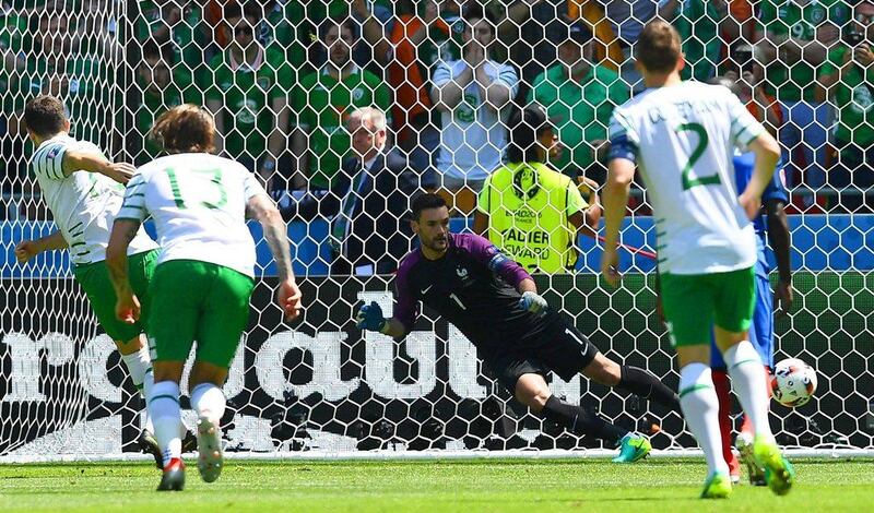 Ireland midfielder Robert Brady shoots to score against France’s goalkeeper Hugo Lloris. Franck Fife / AFP