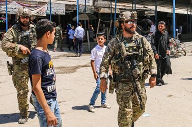 US soldiers in the Syrian town of Ras Al Ain near the Turkish border July 28, 2019. The mixed town is part of large areas in eastern Syria captured by the Kurdish YPG militia, whose rule risks demise because of Washington's troop drawdown. AFP
