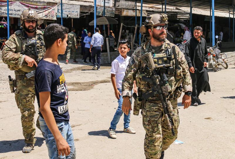 US soldiers in a market in the town of Ras al-Ain in Syria's Hasakeh province near the Turkish border on July 28, 2019. / AFP / -
