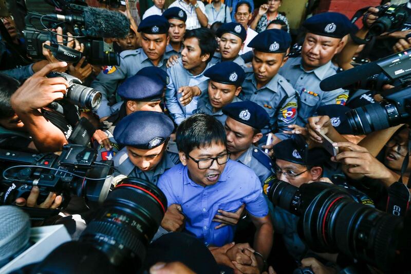 Reuters' journalists Wa Lone and Kyaw Soe Oo are escorted by police as they leave the court after their first trial in Yangon, Myanmar. Lynn Bo Bo / EPA
