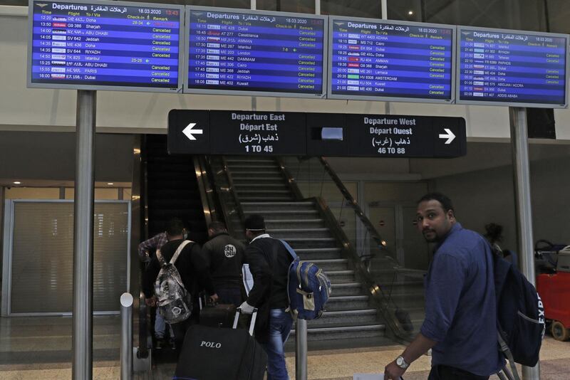 A small number of passengers take the direction of gates before travelling from the Lebanese capital Beirut's Rafiq Hariri international airport with disinfectant, to limit the spread of the Covid-19 coronavirus, on March 18, 2020. (Photo by ANWAR AMRO / AFP)