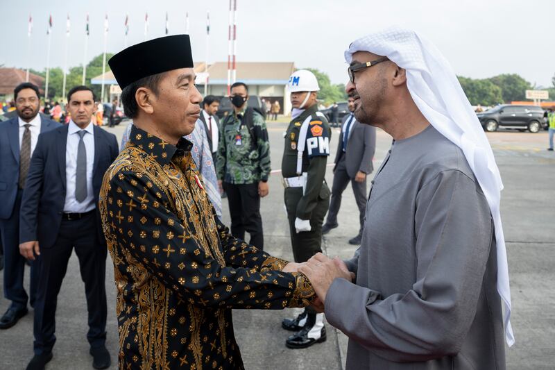 Sheikh Mohamed is welcomed by Mr Widodo at the airport.