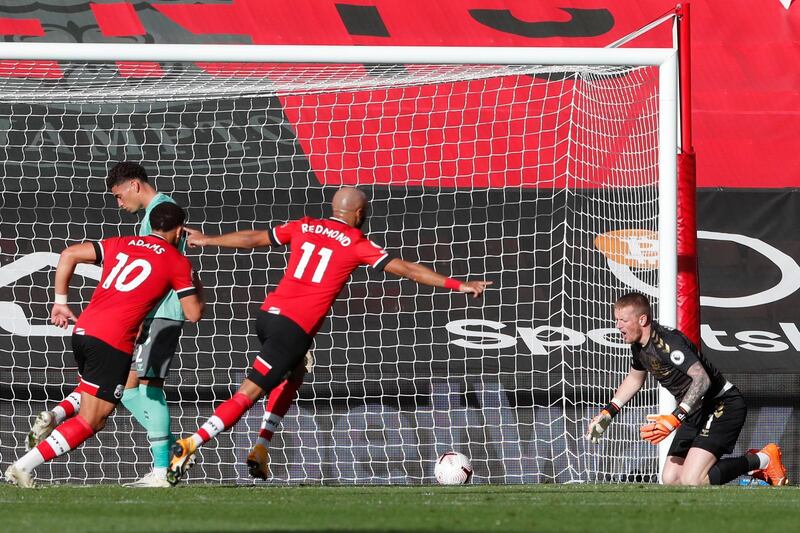 Southampton's Che Adams, left, and Nathan Redmond celebrate after James Ward-Prowse scored his side's opening goal against Everton at the St. Mary's stadium. AP