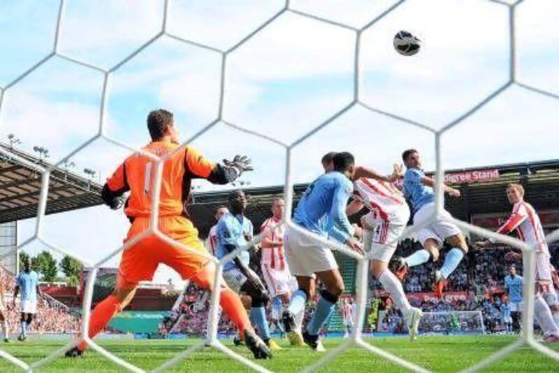 Javi Garcia, second from right, heads in a debut goal for his new club Manchester City to cancel out Peter Crouch's opener for Stoke City at the Britannia Stadium. Adrian Dennis / AFP