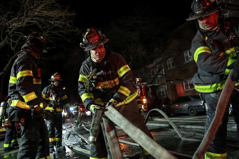 About 170 New York City firefighters worked in extreme cold to put out the fire and rescue about a dozen people from the building. Amr Alfiky / Reuters