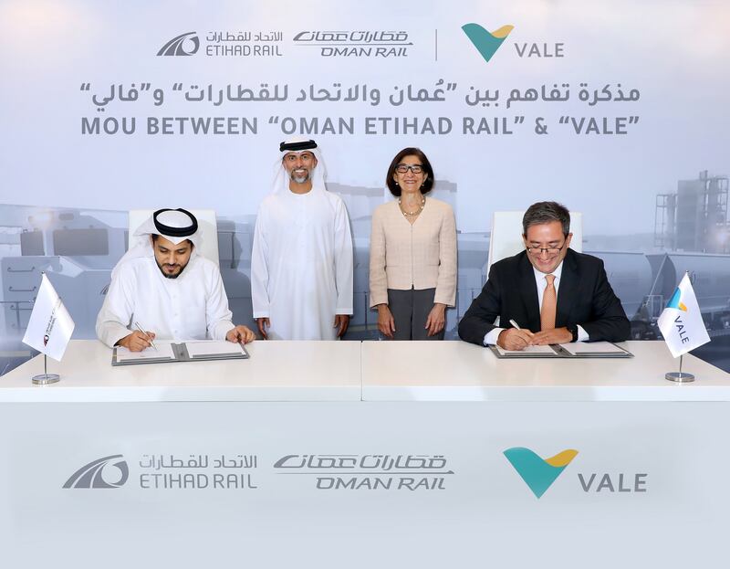 Ahmed Al Hashemi, chief executive of Oman and Etihad Rail Company, and Rogerio Nogueira, director of business development at Vale, sign the agreement, witnessed by Suhail Al Mazrouei, Minister of Energy and Infrastructure and chairman of Oman and Etihad Rail Company, and Elaina Zugaib, Brazi's ambassador to the UAE. Photo: Etihad Rail