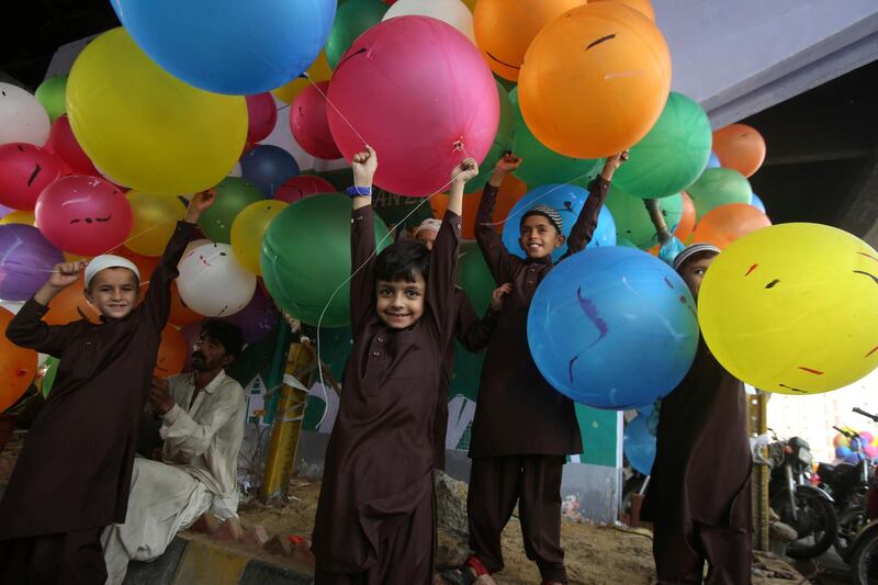 Pakistani children buy balloons to celebrate the Eid al-Fitr, which marks the end of the holy fasting month of Ramadan in Karachi, Pakistan. AP Photo