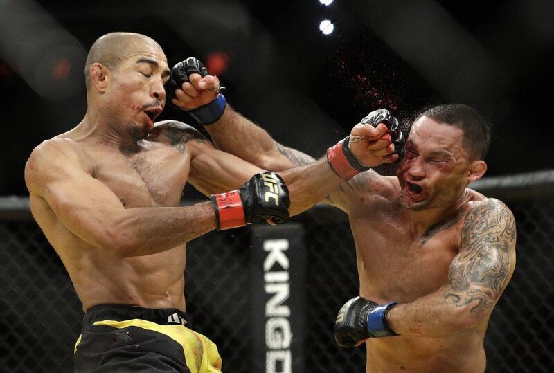 Jose Aldo, left, and Frankie Edgar trade blows during their featherweight championship bout at UFC 200, Saturday, July 9, 2016, in Las Vegas. John Locher / AP Photo