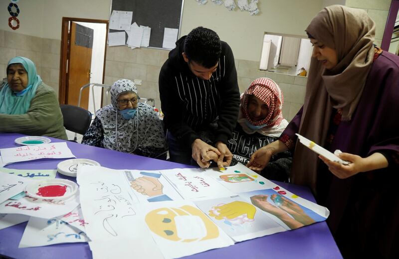 Elderly Palestinians attend an awareness lesson on coronavirus in a nursing home in Jenin, in the Israeli-occupied West Bank, on April 2, 2020. Reuters