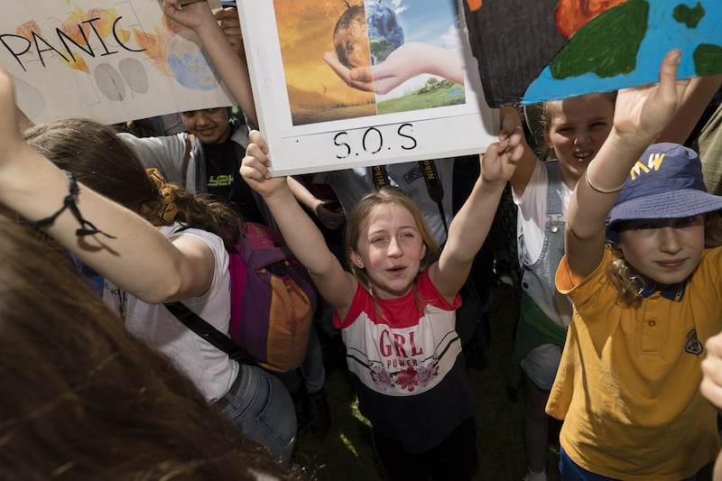Young protesters hold up signs during Climate Strike at the Domain in Sydney. Getty Images