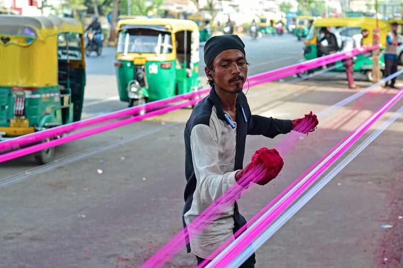 A man coats kite strings with glass powder ahead of the Hindu Uttarayan festival in Ahmedabad, Gujarat, India. AFP