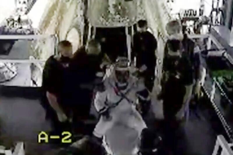 Astronaut Doug Hurley waves as he is assisted out of the SpaceX capsule.  AP