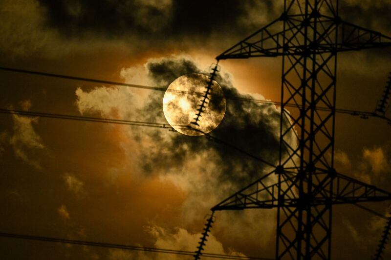 The super full moon through an electric transmission tower in Lambaro, Indonesia's Aceh province. AFP