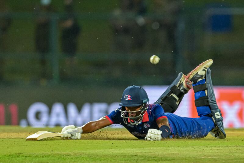 Nepal's Sompal Kami dives to save his wicket. AFP