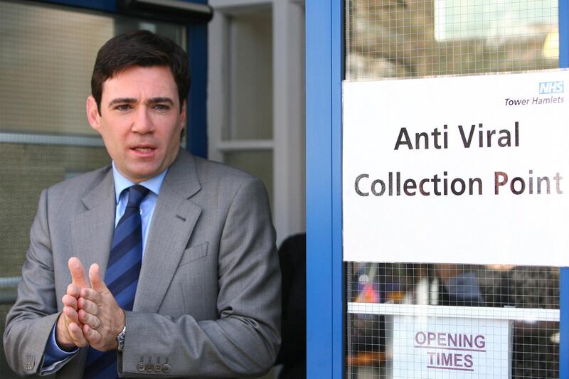 LONDON - JULY 20:  Health Secretary, Andy Burnham rubs disinfectant gel onto his hands after visiting an anti-viral clinic in Tower Hamlets on July 20, 2009 in London, England. Mr Burnham was told how the centre in Tower Hamlets, which dispenses the anti-viral drug Tamiflu, had drawn in volunteers from other areas of the health trust to help it see more than 400 patients a day suffering from swine flu.  (Photo by Johnny Green/WPA-Pool/Getty Images)