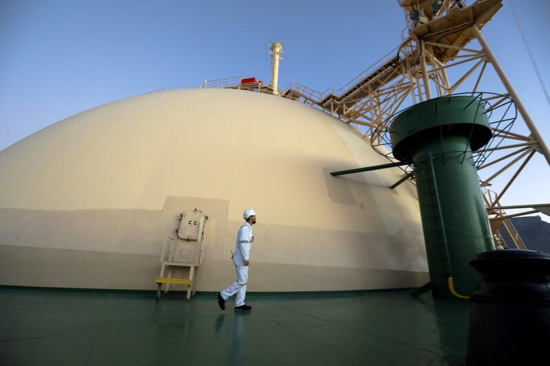 A worker walks past a dome holding liquefied natural gas on a vessel at the Cape Town port. Reuters