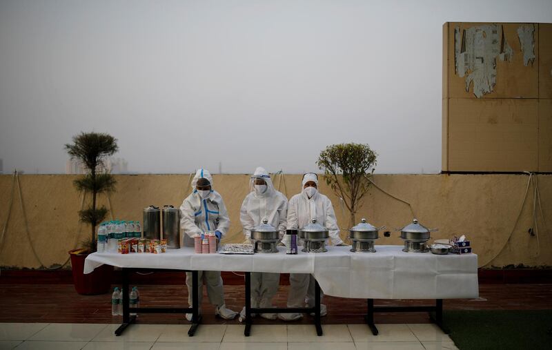 Hospital staff wearing personal protective equipment (PPE) wait for the patients suffering from the coronavirus disease (COVID-19) during an evening buffet at a terrace of the Yatharth Hospital in Noida, on the outskirts of New Delhi, India, September 15, 2020. Picture taken September 15, 2020. REUTERS/Adnan Abidi     TPX IMAGES OF THE DAY