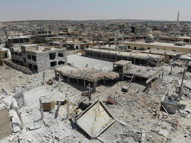 CORRECTION / TOPSHOT - An aerial view taken on August 3, 2019, shows destroyed buildings in the town of Khan Sheikhun in the southern countryside of Idlib. The Syrian government agreed to a truce in the northwestern region of Idlib on condition that a Turkish-Russian buffer-zone deal is implemented, according to state news agency SANA. Air strikes on the Idlib region stopped after the government's truce announcement but the fighting since late April has killed 790 civilians in regime and Russian attacks, the UK-based Syrian Observatory for Human Rights monitor says.  / AFP / Omar HAJ KADOUR
