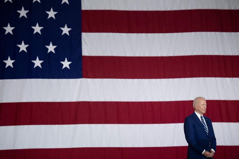 TOPSHOT - US President Joe Biden listens while US First Lady Jill Biden speaks at Joint Base Langley-Eustis on May 28, 2021, in Hampton, Virginia. / AFP / Brendan Smialowski
