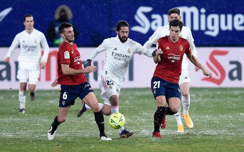 Isco of Real Madrid battles for possession with Oier Sanjurjo and Inigo Perez of Osasuna. Getty