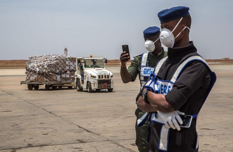 Senegales authorities and airport staff unload cargo sent from Alibaba co-founder, Jack Ma, after it arrives at at the Dakar-Blaise Diagne Airport in Dakar, Senegal.  AFP