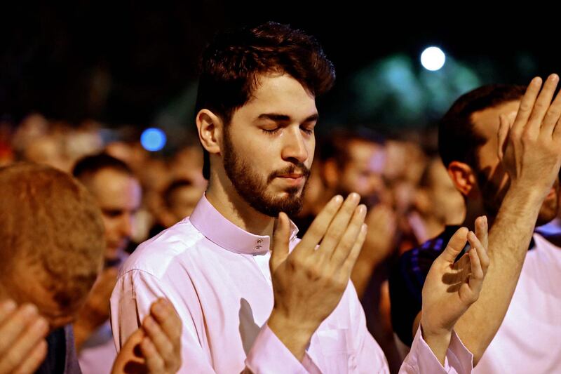 Palestinian worshippers pray outside the Dome of the Rock in Jerusalem's Al Aqsa Mosque compound, seeking Laylat Al Qadr or the Night of Destiny. AFP