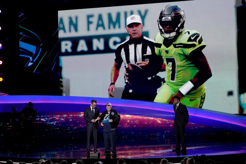 Presenter Joel McHale, left, accepts the award for AP Comeback Player of the Year on behalf of Seattle Seahawks' Geno Smith. AP Photo
