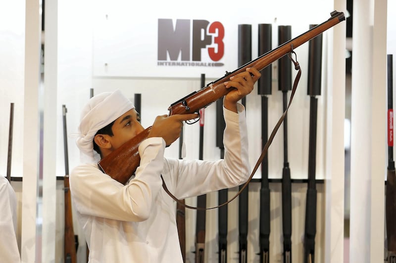 ABU DHABI ,  UNITED ARAB EMIRATES , AUGUST 27 – 2019 :- Visitor looking guns at the MP3 stand during the ADIHEX 2019 held at ADNEC in Abu Dhabi. ( Pawan Singh / The National ) For News/Online/Instagram/Big Picture. Story by Daniel 