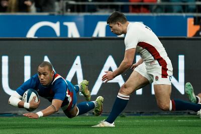 France's Gael Fickou dives over to score the opening try. AP