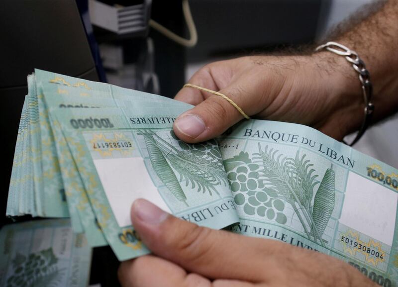 FILE PHOTO: A man counts Lebanese pounds at an exchange office in Beirut, Lebanon, August 16, 2018. REUTERS/Mohamed Azakir/File Photo