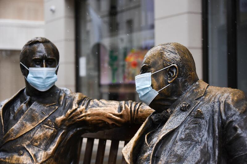 Face coverings are placed on the statues of former US President Franklyn D. Roosevelt and former British Prime Minister Winston Churchill in Mayfair, London. AP Photo