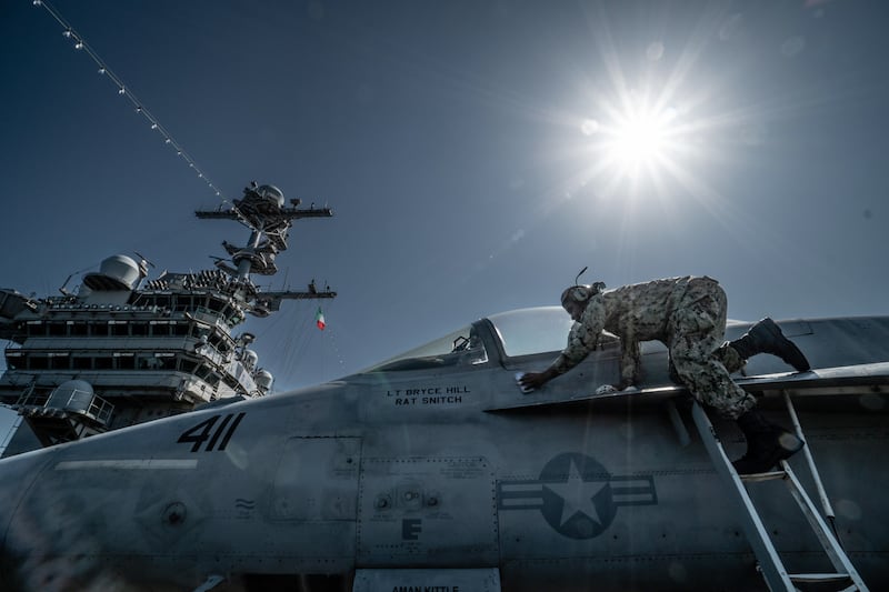 A military plane is cleaned aboard the US aircraft carrier 'Harry S. Truman' in the Gulf of Naples, Italy. EPA