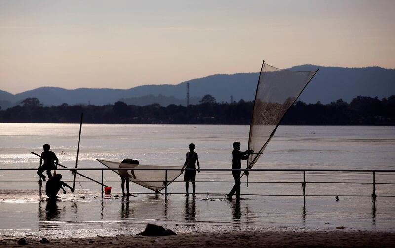 Indians fish with nets during a fresh lockdown to combat the spread of the coronavirus, in the river Brahmaputra in Gauhati, India. AP Photo