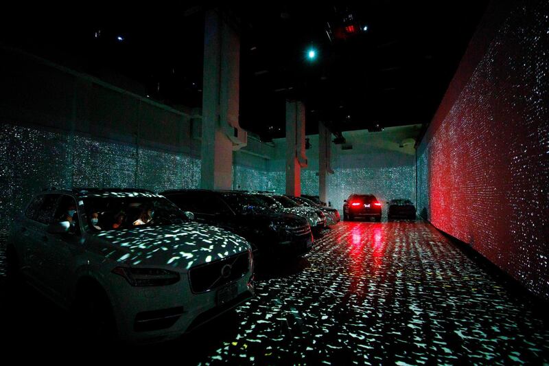 People sit in their cars as they experience a drive-in immersive Vincent Van Gogh art exhibit in Toronto, Ontario, Canada. AFP