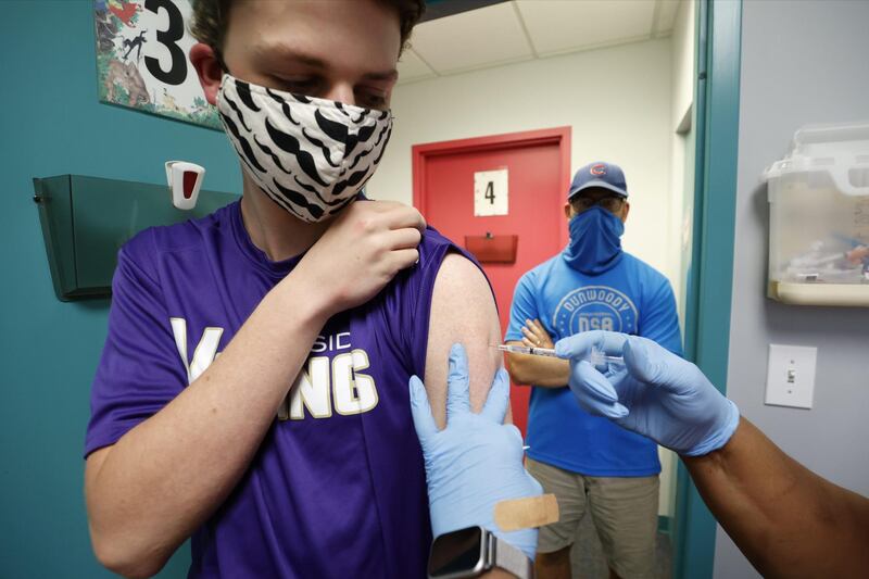  Timothy Frilingos watches as his son, Paul Frilingos, 15, is  inoculated with Pfizer's vaccine against coronavirus disease (COVID-19) after Georgia authorized the vaccine for ages over 12 years, at Dekalb Pediatric Center in Decatur, Georgia, U.S. May 11, 2021.   REUTERS/Chris Aluka Berry