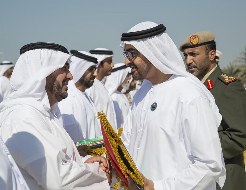 Sheikh Mohammed bin Zayed presents a Martyr’s Medal to a relative of a soldier. Ryan Carter / Crown Prince Court of Abu Dhabi
