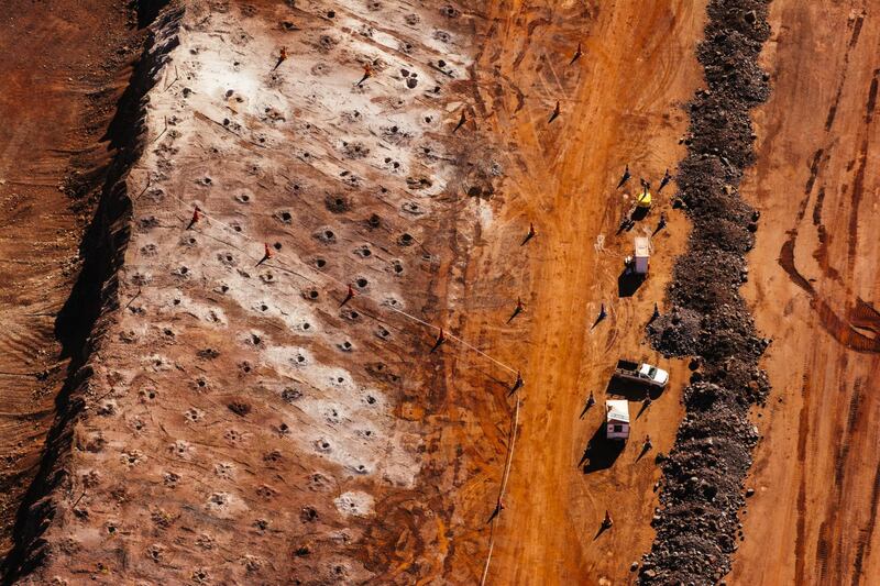 Access roads for trucks line the iron ore excavation pit at the Sishen open cast mine, operated by Kumba Iron Ore Ltd., an iron ore-producing unit of Anglo American Plc, in Sishen, South Africa, on Tuesday, May 22, 2018. Kumba Iron Ore may diversify into other minerals such as manganese and coal as Africa’s top miner of the raw material seeks opportunities for growth and to shield its business from price swings. Photographer: Waldo Swiegers/Bloomberg