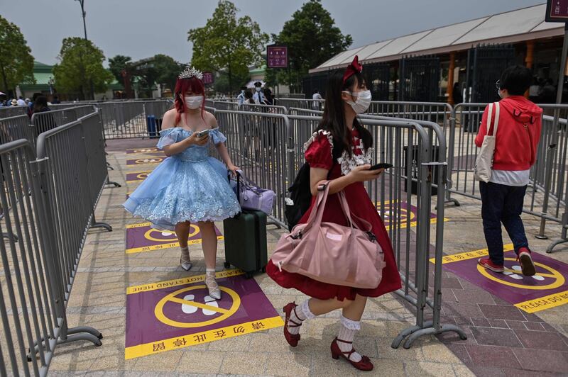 Tourists follow social-distancing guidelines as they enter Shanghai Disneyland. AFP