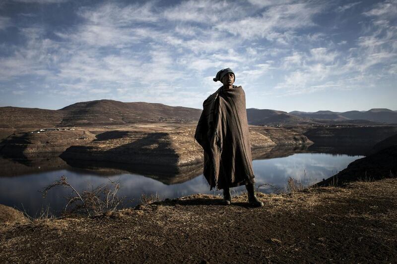 Shepherd Ntoaesele Mashongoane, 32, calls to his flock near the Katse dam in Lesotho on July 13, 2016. John Wessels / AFP