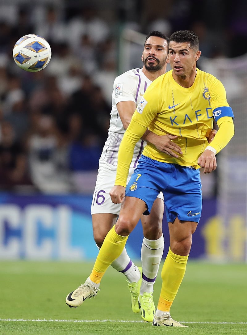 Al Nassr's Cristiano Ronaldo vies for the ball against Al Ain's Khalid Al Hashemi.