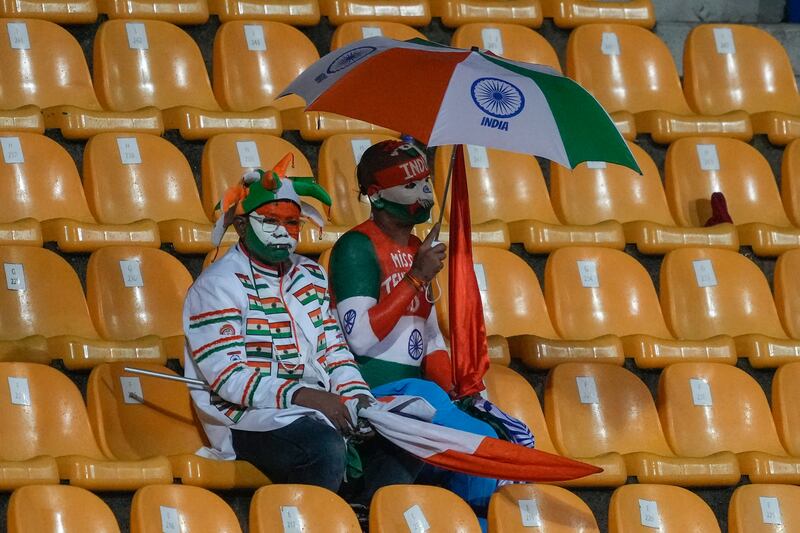 Indian fans wait as the play is interrupted by rain in Kandy. AP