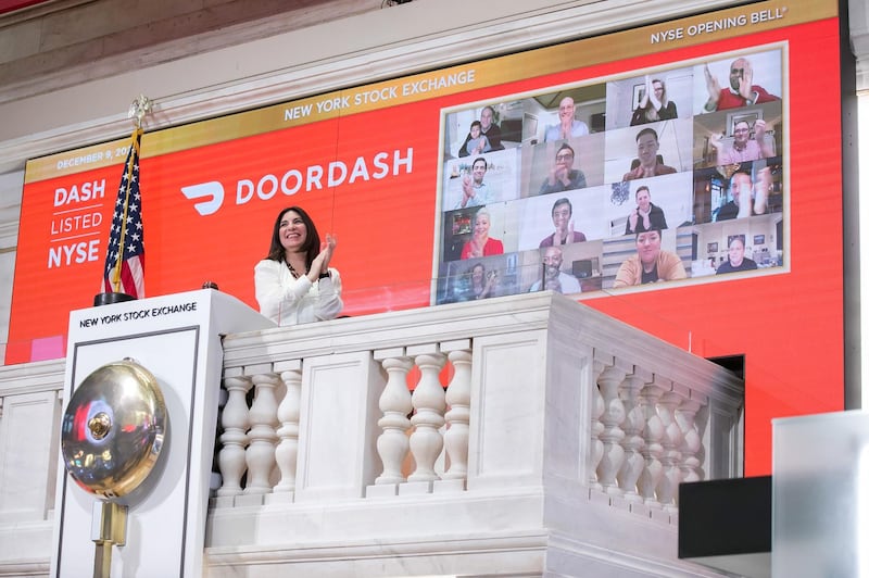 epa08873231 A handout photo made available by the NYSE showing New York Stock Exchange President Stacey Cunningham ringing the opening bell as a video screen shows executives and guests of the delivery company DoorDash to mark the company’s initial public offering (IPO) at the NYSE in New York, New York, USA, 09 December 2020. Shares of the food delivery company were initially priced at 102 US dollars per share but started selling above expectations at 182 US dollars per share.  EPA/COURTNEY CROW / NYSE HANDOUT  HANDOUT EDITORIAL USE ONLY/NO SALES