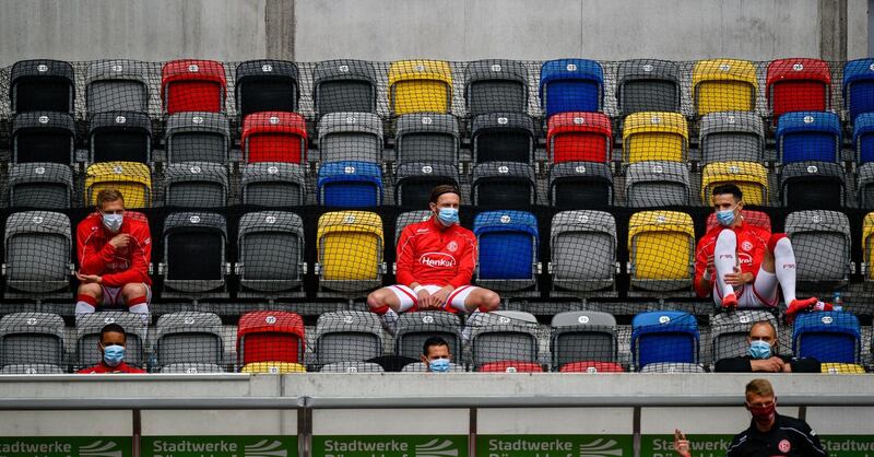 Fortuna Dusseldorf's players sit on the bench during the  Bundesliga match at home to Paderborn.  AFP