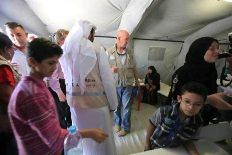 The UNHCR representative to Jordan, Andrew Harper, centre, tours the Emirati-Jordanian Field Hospital in Mafraq.