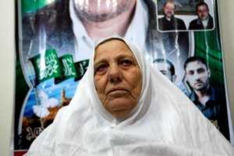 The mother of Mahmud Abdel Rauf al-Mabhuh (portraits), one of the founders of Hamas' military wing who died in Dubai, holds his picture at her home in the northern Gaza Strip refugee camp of Jabalia on January 29, 2010. The Islamist Hamas movement blamed Israel for Mabhuh's January 20 death and his brother Fayeq said he was killed by electrocution. There was no immediate Israeli reaction to the accusation. Born in Jabalia in 1960, Mabhuh was one of the founders of Hamas's Ezzedine al-Qassam Brigades.  AFP PHOTO/MOHAMMED ABED *** Local Caption ***  738121-01-08.jpg *** Local Caption ***  738121-01-08.jpg